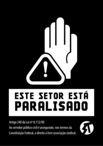 cartaz "Este setor está paralisado" com fundo preto